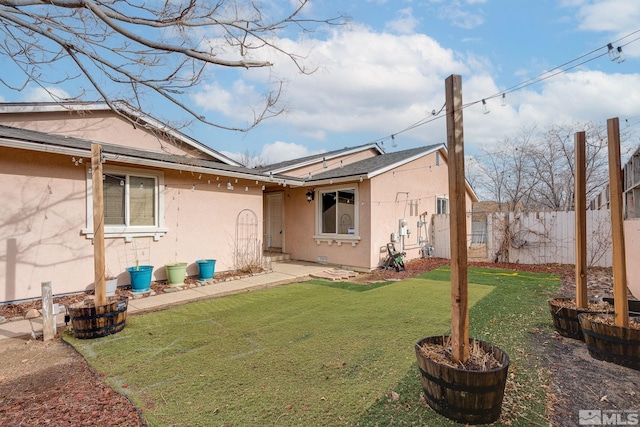 rear view of property featuring a yard