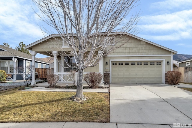 view of front of property featuring a porch, a garage, and a front yard