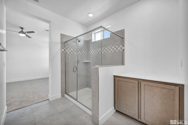 bathroom featuring ceiling fan and walk in shower