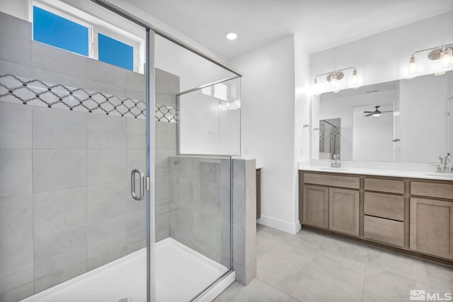 bathroom featuring ceiling fan, vanity, and a shower with shower door