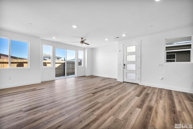 unfurnished living room featuring light hardwood / wood-style flooring and ceiling fan