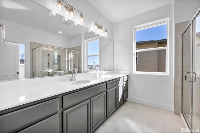 bathroom with tile patterned floors, a shower with door, and vanity