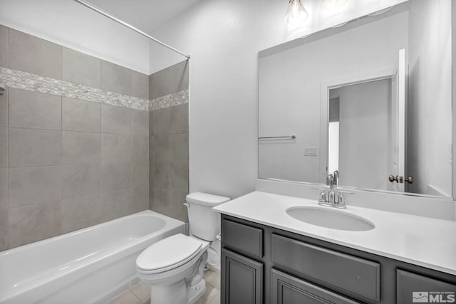 full bathroom featuring vanity, tile patterned flooring, tiled shower / bath combo, and toilet