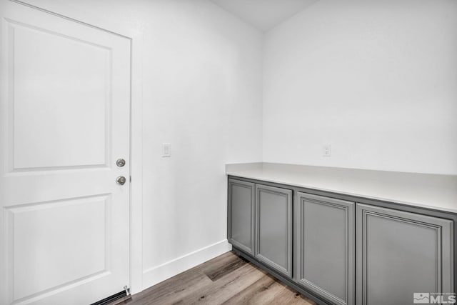 laundry room featuring light wood-type flooring