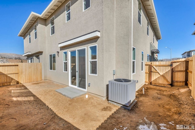 back of property featuring central AC unit