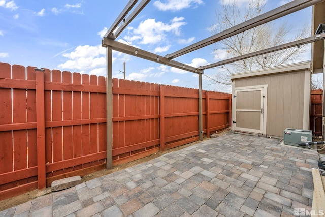 view of patio featuring a storage unit