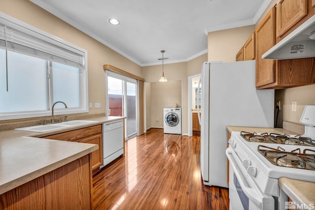 kitchen with sink, washer / clothes dryer, decorative light fixtures, white appliances, and exhaust hood