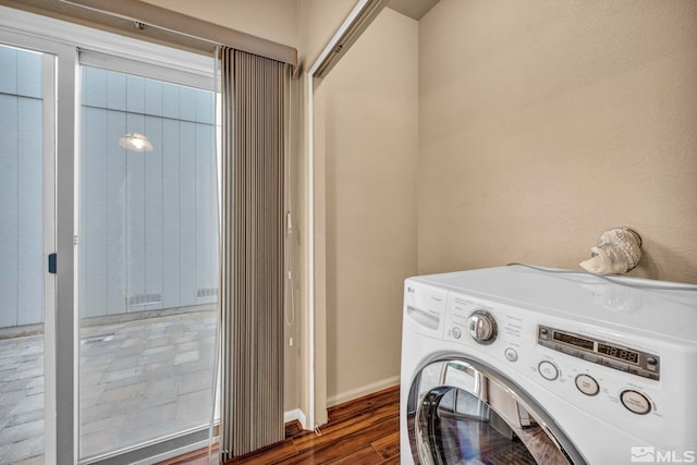 laundry area with washer / dryer and dark wood-type flooring