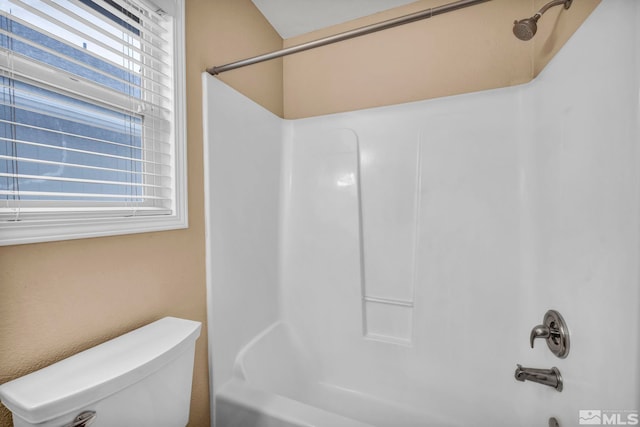 bathroom with toilet and shower / washtub combination