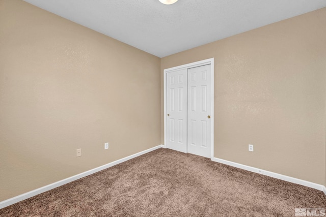 unfurnished bedroom with carpet flooring and a closet