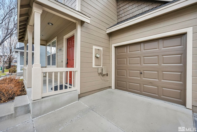 exterior space featuring a porch and a garage