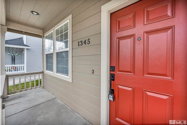 view of exterior entry with covered porch