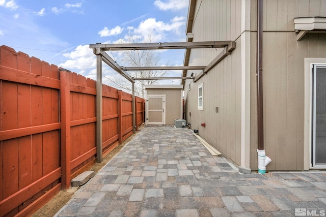 view of patio / terrace with a storage shed