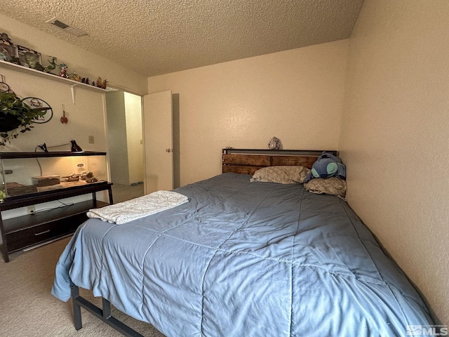 carpeted bedroom with a textured ceiling