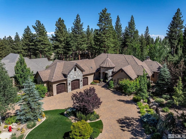 view of front of home with a front lawn and a garage