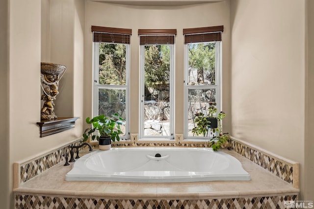 bathroom featuring a relaxing tiled tub