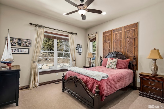 bedroom with ceiling fan and light carpet