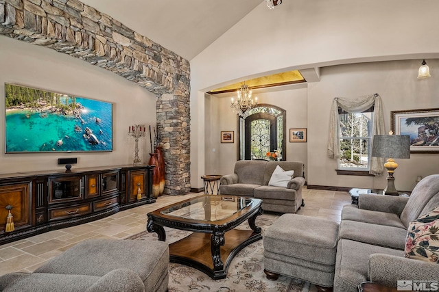 living room with high vaulted ceiling and an inviting chandelier