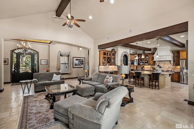 living room featuring beam ceiling, high vaulted ceiling, and ceiling fan with notable chandelier