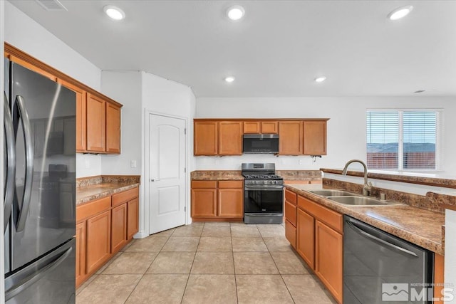 kitchen with sink, light tile patterned floors, and stainless steel appliances