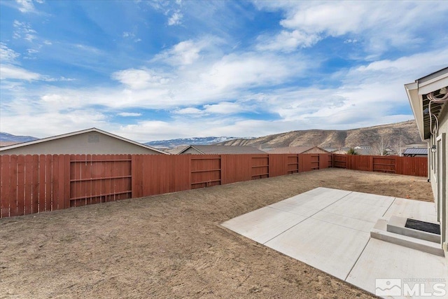 view of yard featuring a mountain view and a patio area