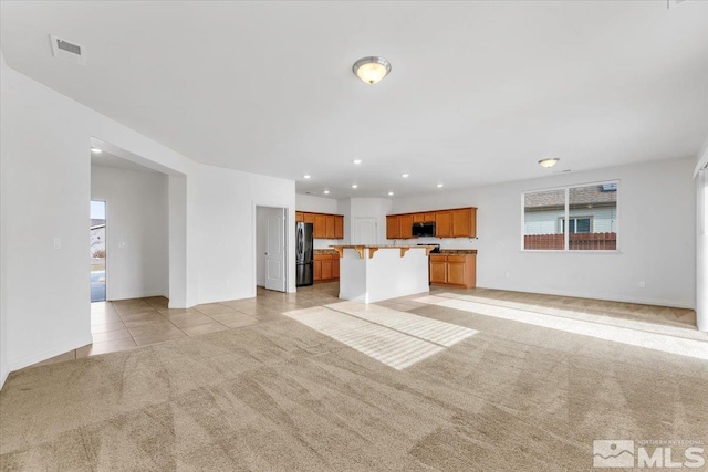 unfurnished living room with light carpet