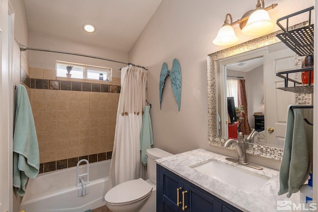 full bathroom with vanity, toilet, and shower / bath combo with shower curtain