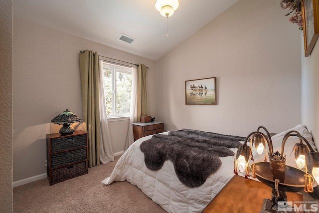 bedroom with light carpet and vaulted ceiling