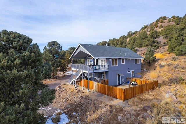 rear view of property with a wooden deck