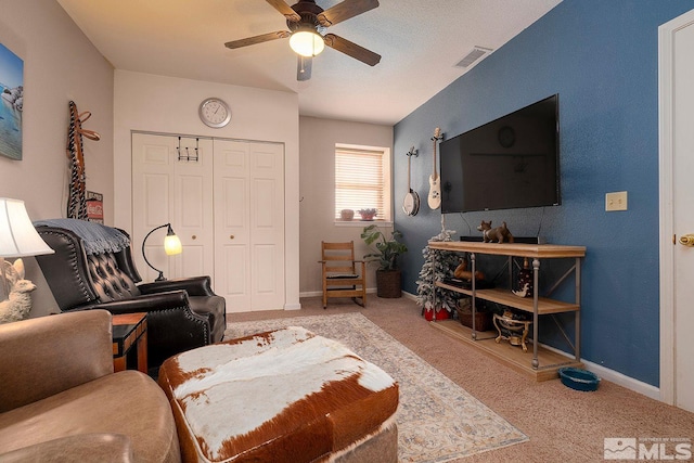 carpeted living room featuring ceiling fan