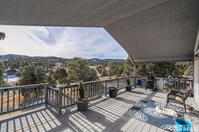 wooden deck featuring a mountain view and grilling area