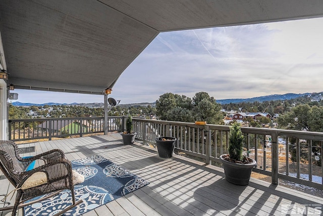 wooden deck with a mountain view