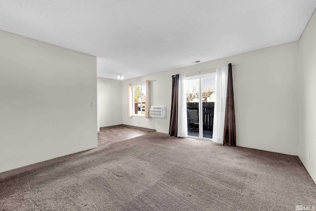 carpeted spare room with a textured ceiling