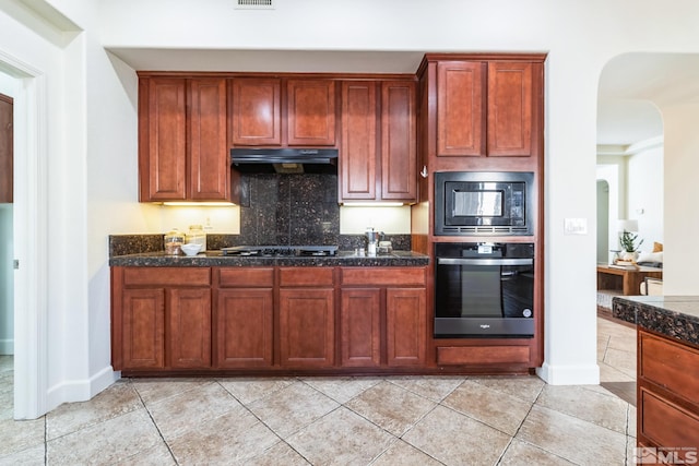 kitchen with decorative backsplash, light tile patterned flooring, and black appliances