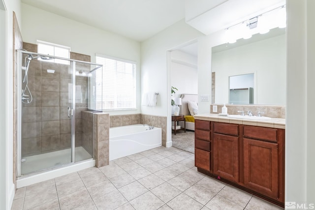 bathroom with tile patterned flooring, vanity, and plus walk in shower