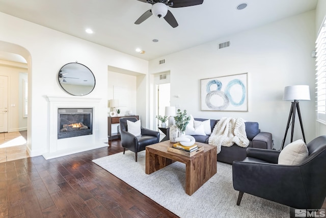 living room with ceiling fan and dark hardwood / wood-style floors