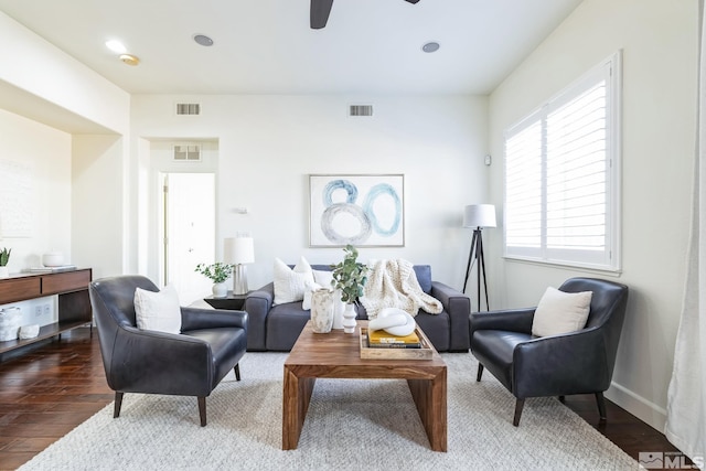 sitting room with ceiling fan and wood-type flooring