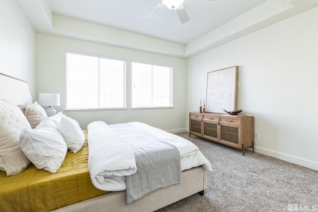 bedroom featuring carpet flooring, ceiling fan, and a raised ceiling