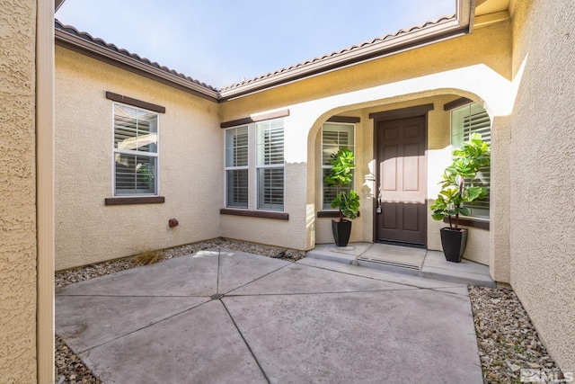 doorway to property with a patio area