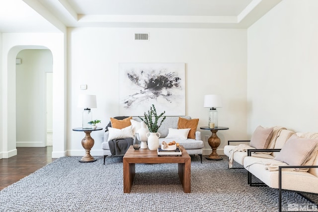 sitting room featuring dark hardwood / wood-style floors and a raised ceiling