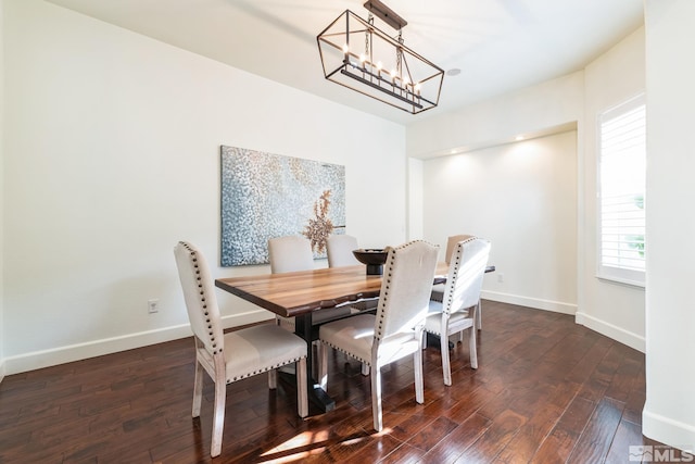 dining area with a notable chandelier and dark wood-type flooring