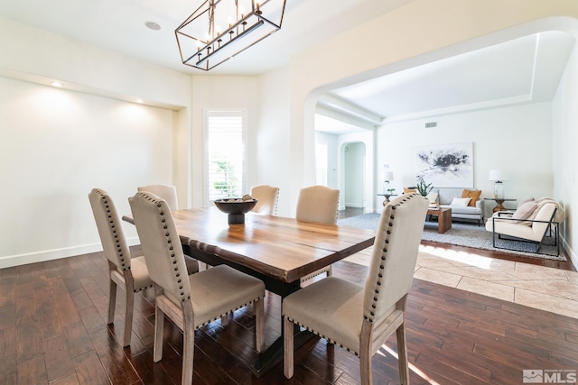 dining space with dark wood-type flooring