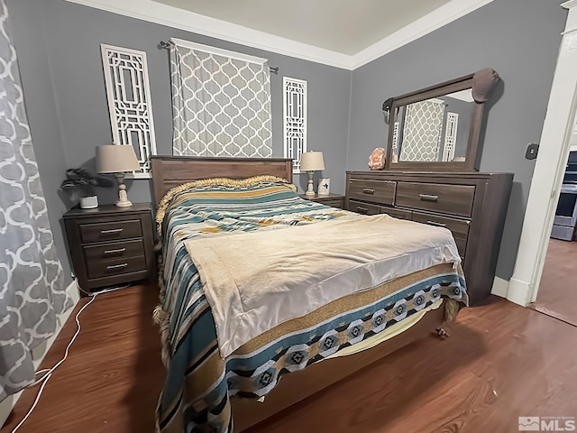 bedroom with dark hardwood / wood-style flooring and crown molding