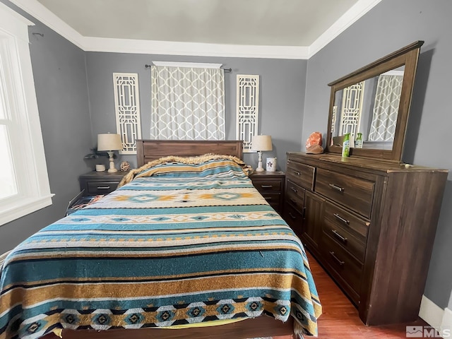 bedroom featuring hardwood / wood-style floors and crown molding