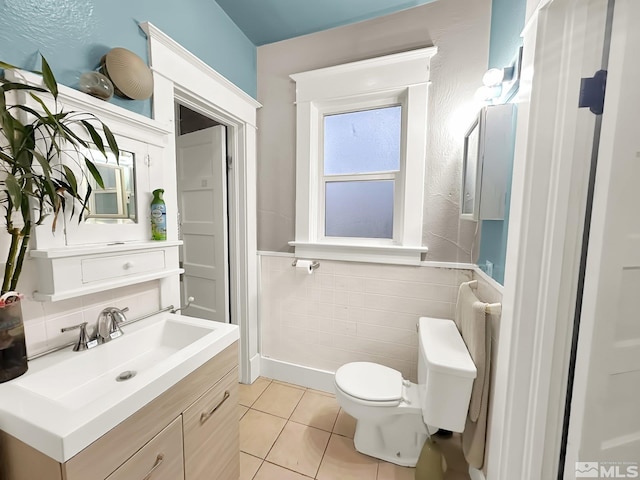 bathroom featuring vanity, tile patterned floors, toilet, tile walls, and radiator heating unit