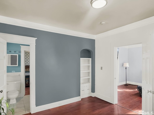 unfurnished room with dark hardwood / wood-style flooring and ornamental molding