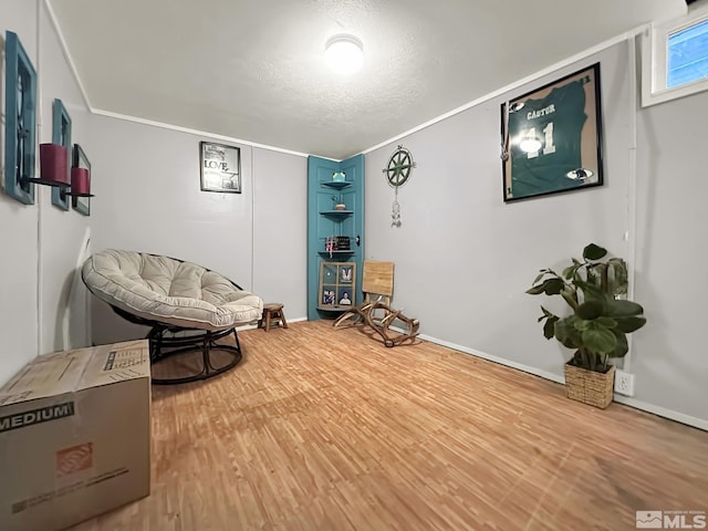 living area with a textured ceiling and hardwood / wood-style flooring