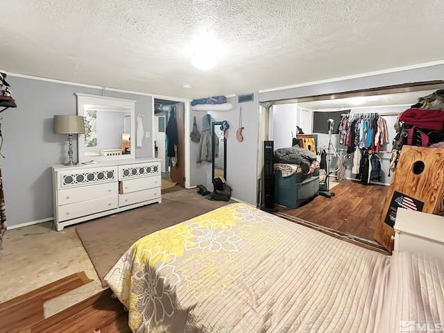 bedroom featuring a closet, concrete floors, and a textured ceiling