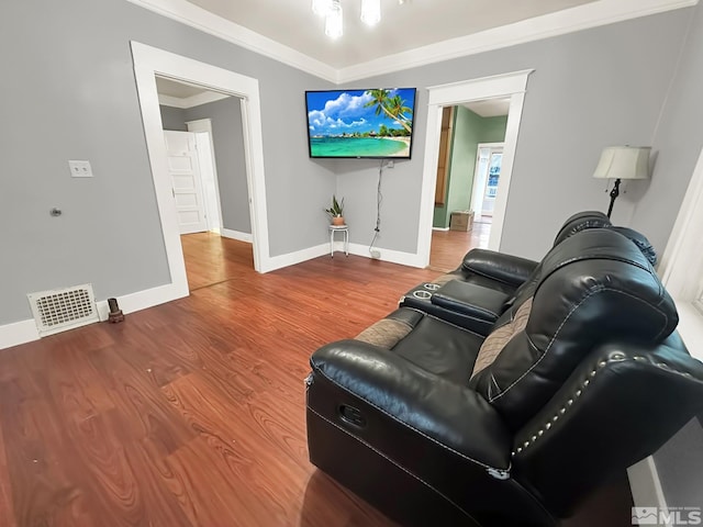 living room featuring wood-type flooring and ornamental molding