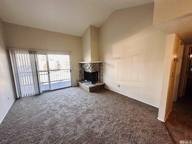 unfurnished living room with dark carpet, a fireplace, and vaulted ceiling